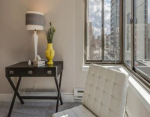 Chair, end table, lamp and vase with flowers