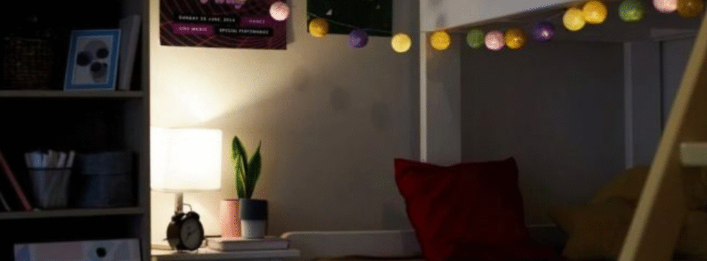 Picture of a college dorm, desk and bunk bed.