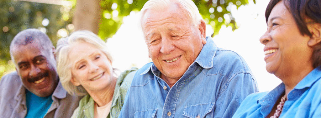 Senior citizens laughing in a community park.
