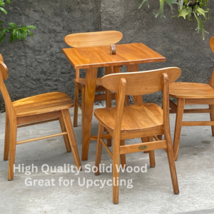 Wood table and 4 wood chairs outside.