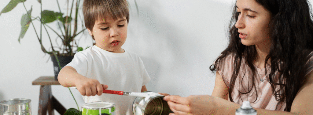 A boy and a woman painting cans.
