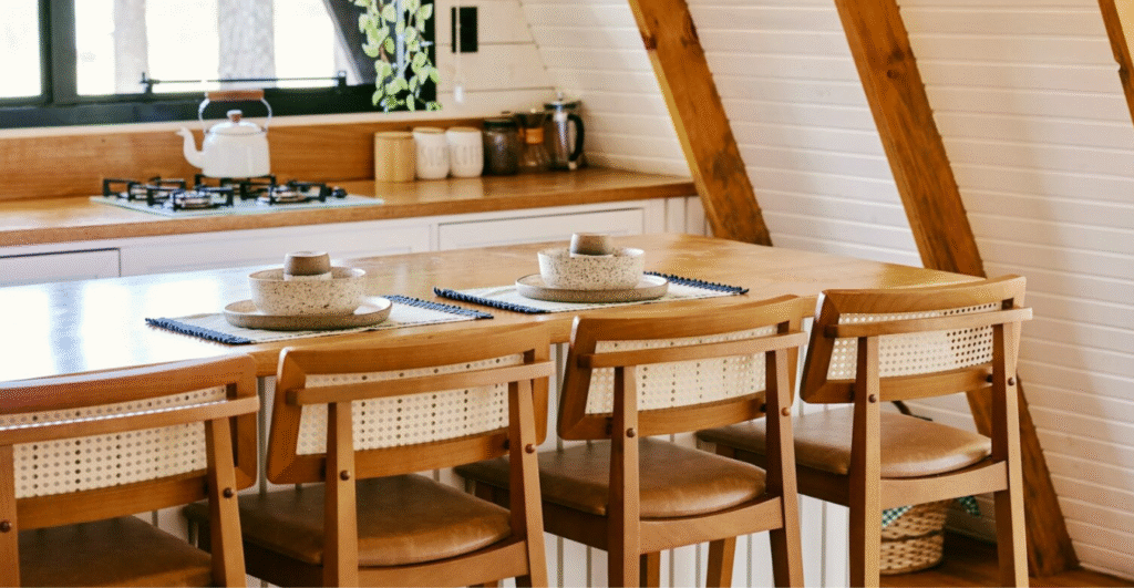Small kitchen with wood table and chairs.