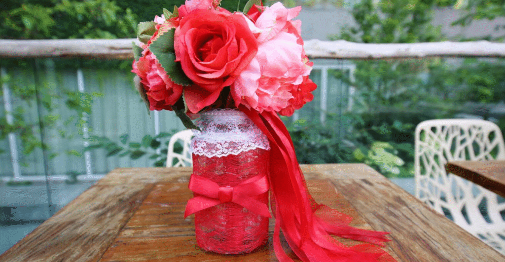 Mason jar with lace an bow. Filled with flowers.